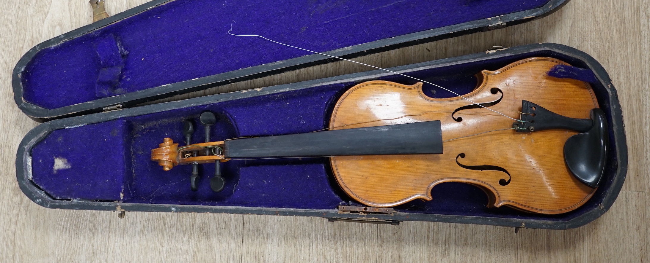 A wooden cased early 20th century Czechoslovakian student’s violin, bears ‘Copy of Stradivarius’ label, body length, 35.5cm, without bow